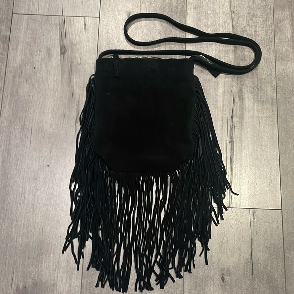 Boho leather Crossbody bag with long tassels. Made by lost & found brand. ￼